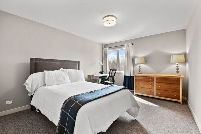 a bed room with a bed and a dresser