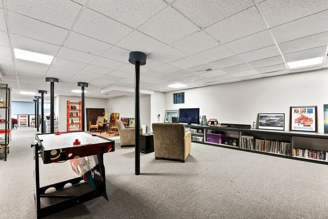 a living room with furniture a flat screen tv and a table