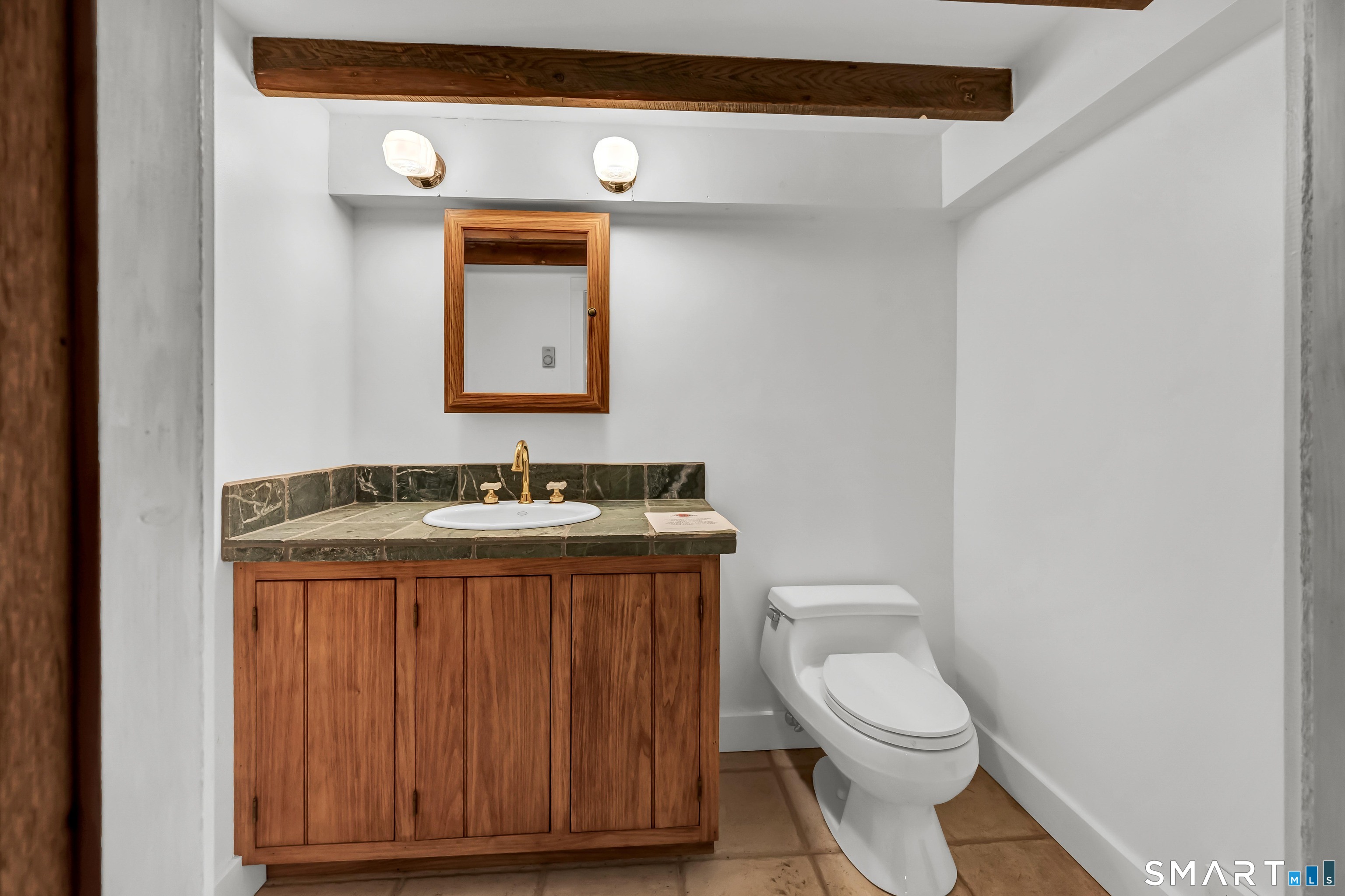 139 West Side Road Goshen, CT 06756 - Photo 17 of 17 a bathroom with a granite countertop toilet sink and mirror