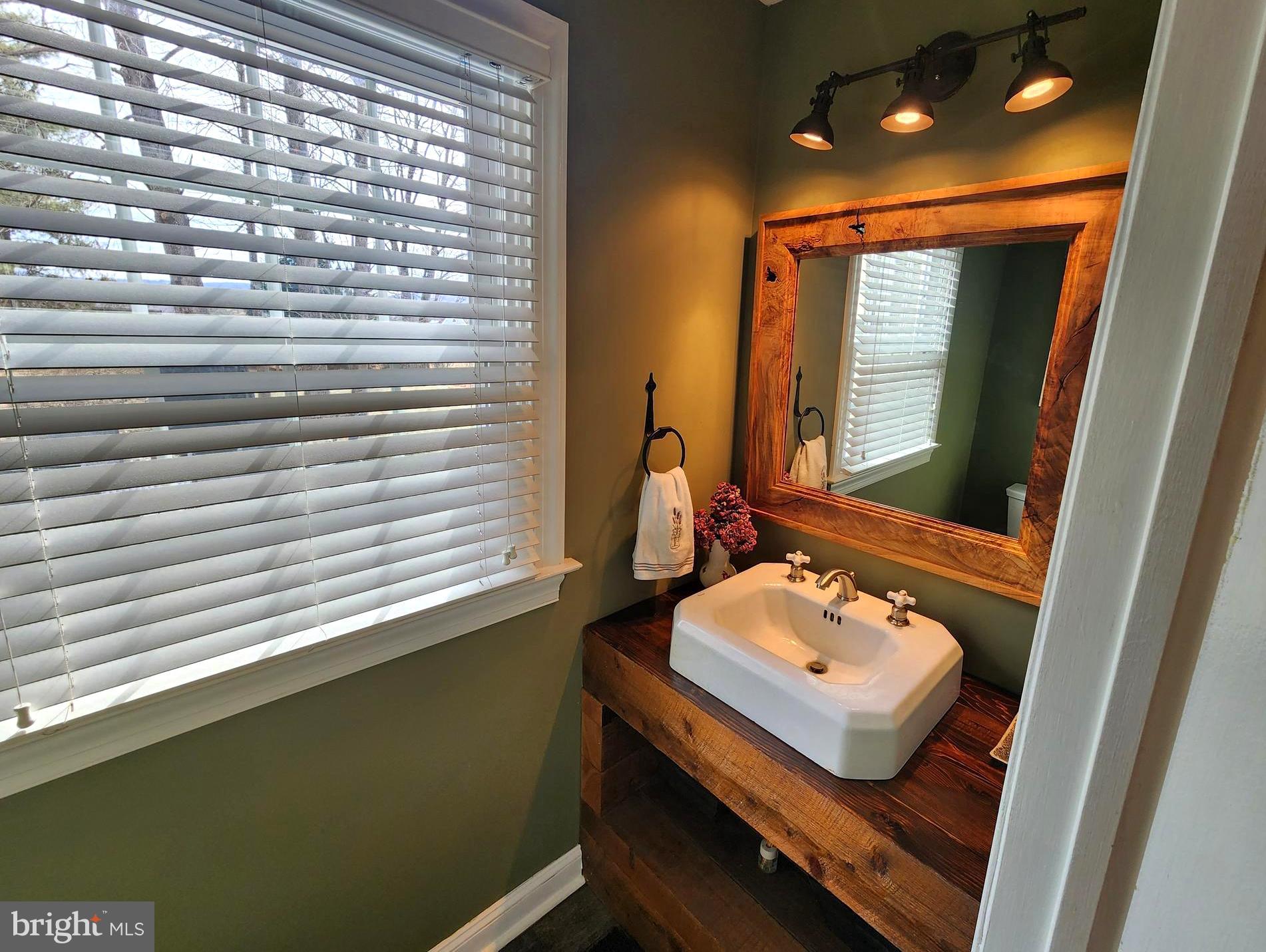 6774 Chapel Road New Hope, PA 18938 - Photo 23 of 59 a bathroom with a sink a mirror and a window