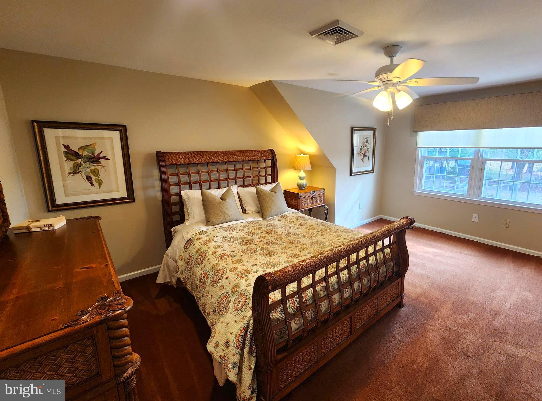 6774 Chapel Road New Hope, PA 18938 - Photo 36 of 59 a bedroom with a bed chandelier and a window