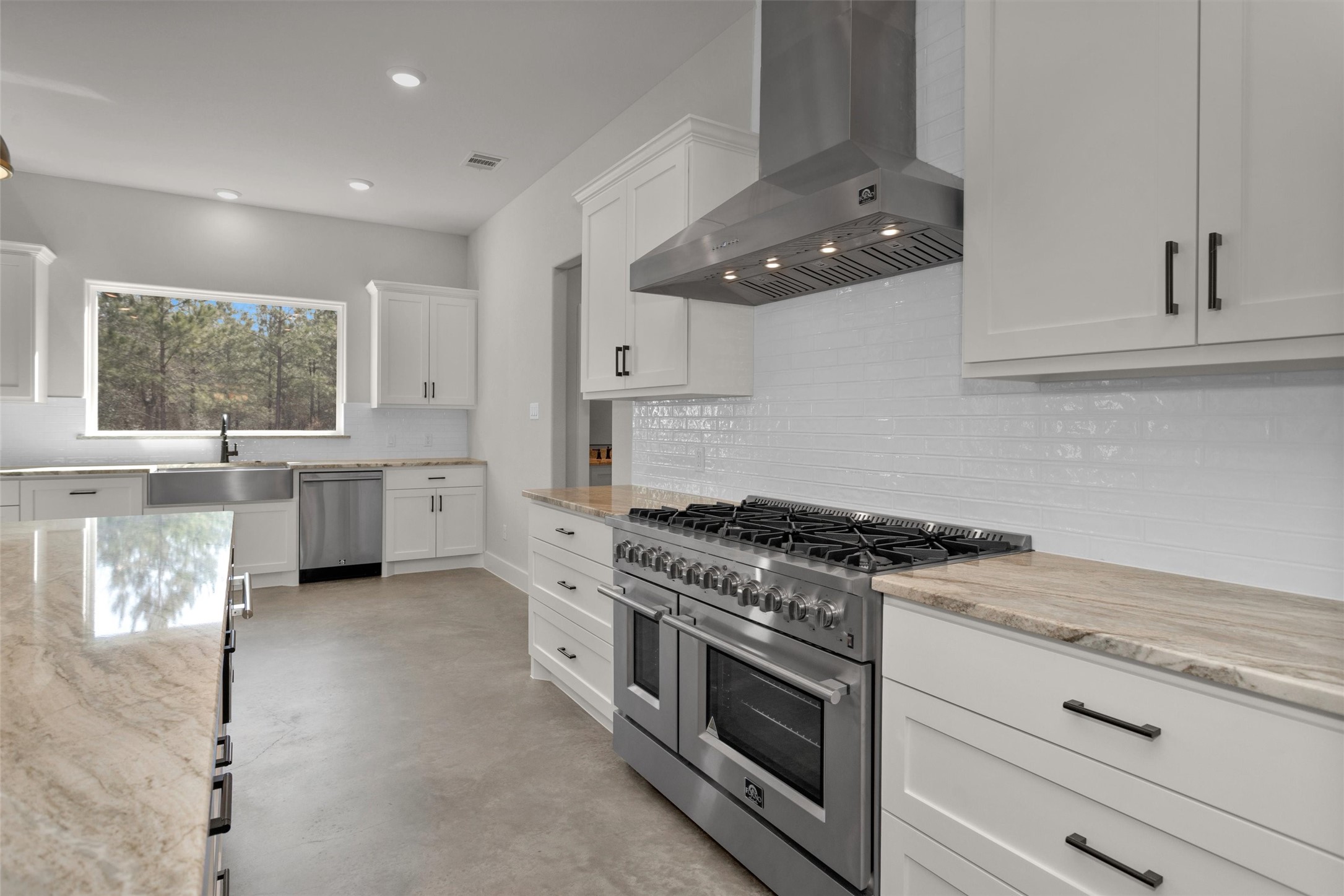 12744 Oak Barrel Road Willis, TX 77378 - Photo 14 of 50 The kitchen is beautifully appointed with premium Forno appliances, combining sleek design with exceptional performance. These high-end appliances elevate both the functionality and style of the space, offering modern convenience for everyday cooking and entertaining.