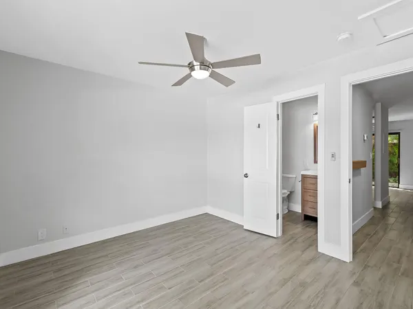 a bathroom with a granite countertop toilet a sink and a bathtub