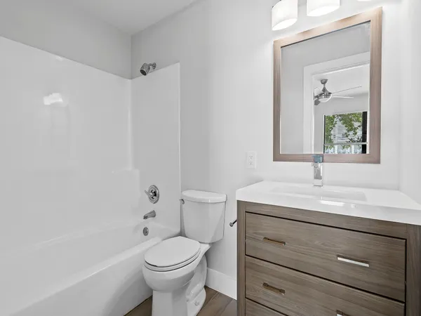 a kitchen with stainless steel appliances wooden floor sink and cabinets