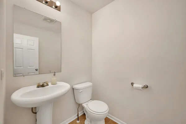 a white toilet sitting next to a white sink