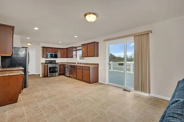 a large kitchen with stainless steel appliances granite countertop a large counter top and a stove