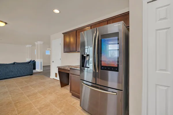 a kitchen with stainless steel appliances granite countertop a refrigerator and a sink