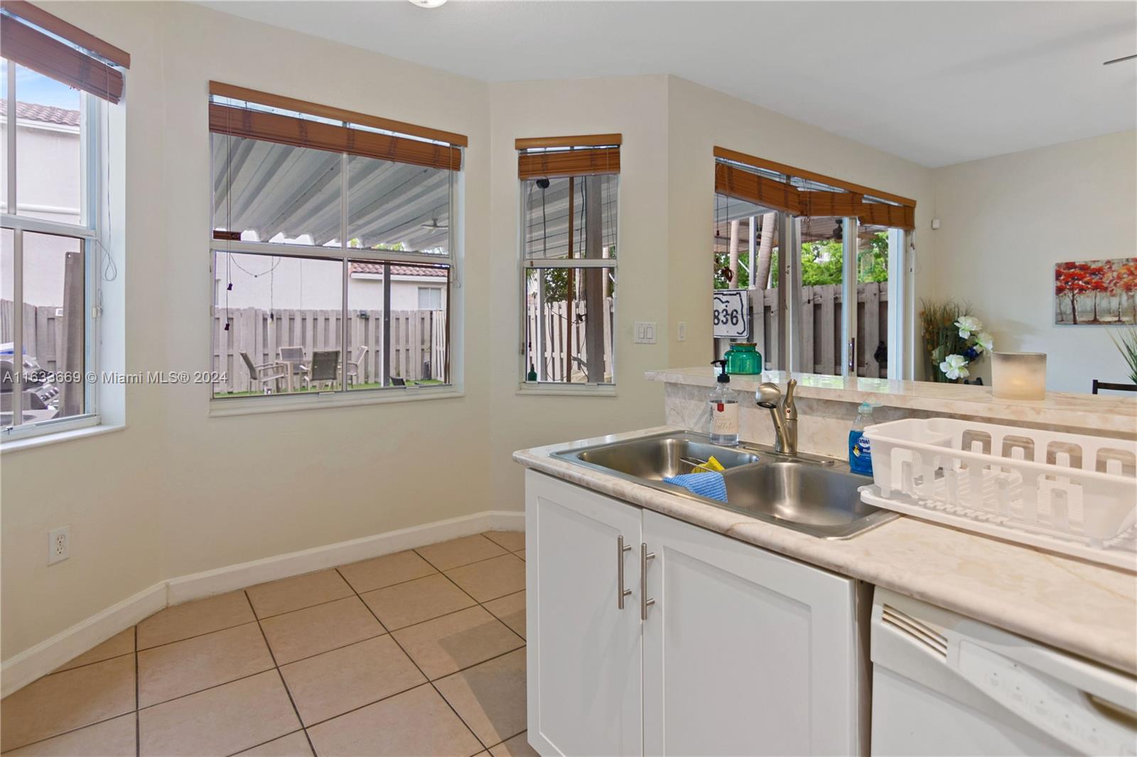 11051 Southwest 246th Street Homestead, FL 33032 - Photo 12 of 30 a kitchen with stainless steel appliances granite countertop a sink and a window