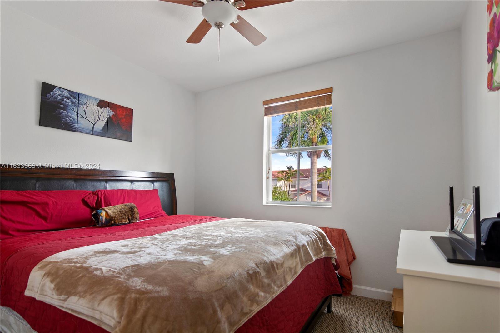 11051 Southwest 246th Street Homestead, FL 33032 - Photo 15 of 30 a bedroom with a bed and a painting on the wall