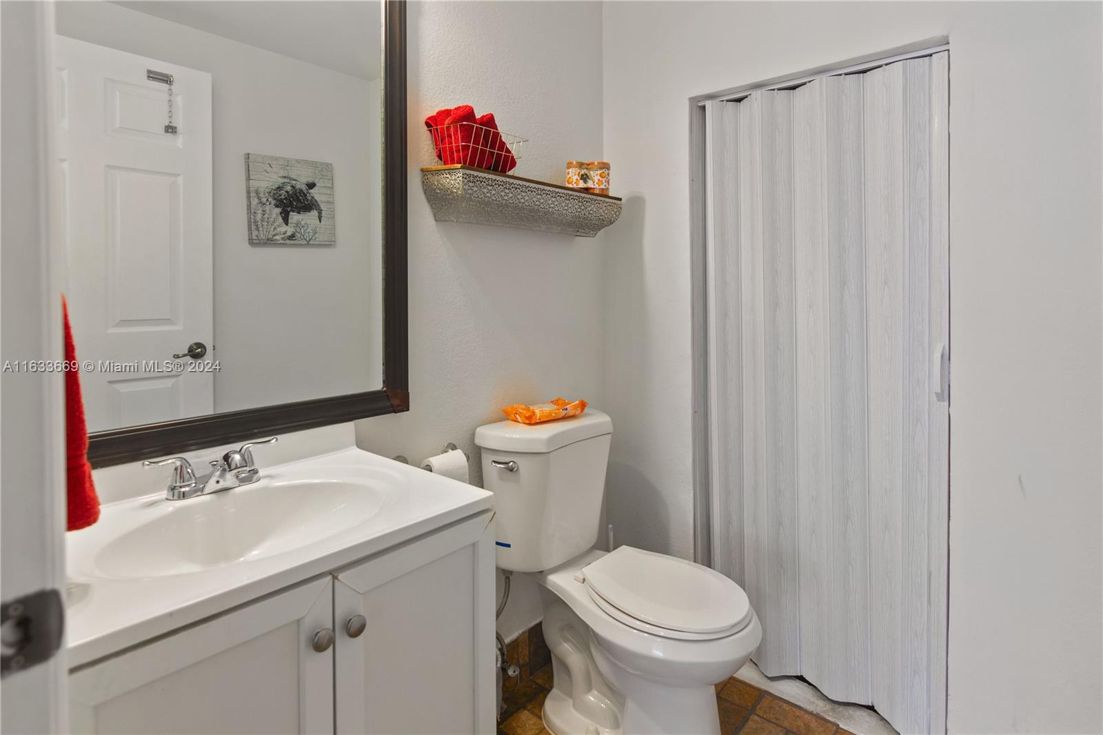 11051 Southwest 246th Street Homestead, FL 33032 - Photo 16 of 30 a bathroom with a sink a toilet and a mirror