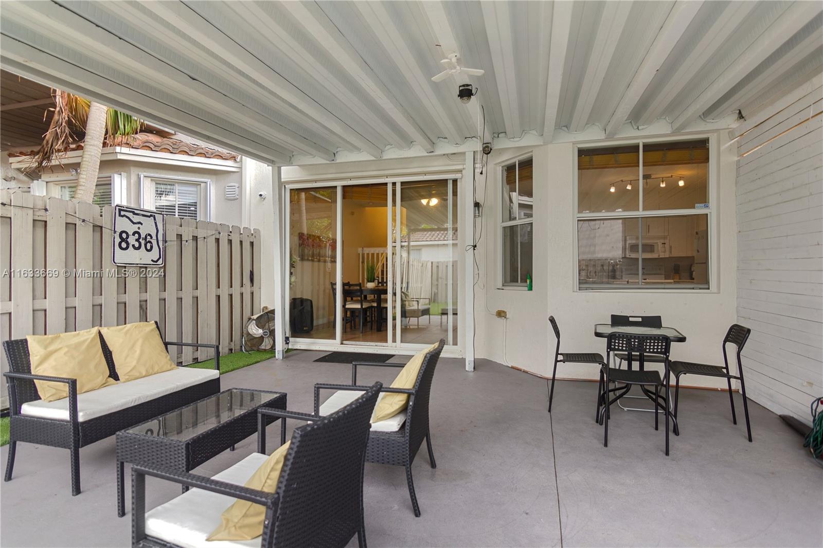 11051 Southwest 246th Street Homestead, FL 33032 - Photo 24 of 30 a view of a patio with a table and chairs