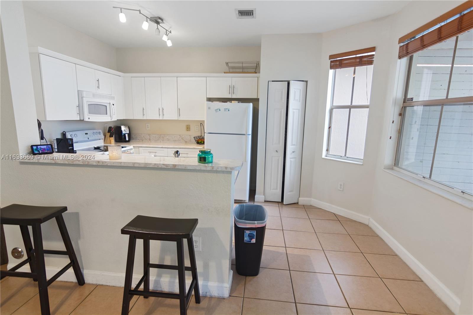11051 Southwest 246th Street Homestead, FL 33032 - Photo 9 of 30 a kitchen with stainless steel appliances a refrigerator sink and cabinets