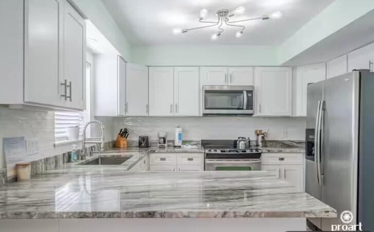 186 Durango Road Destin, FL 32541 - Photo 5 of 29 a kitchen with stainless steel appliances granite countertop a refrigerator a stove a sink and dishwasher