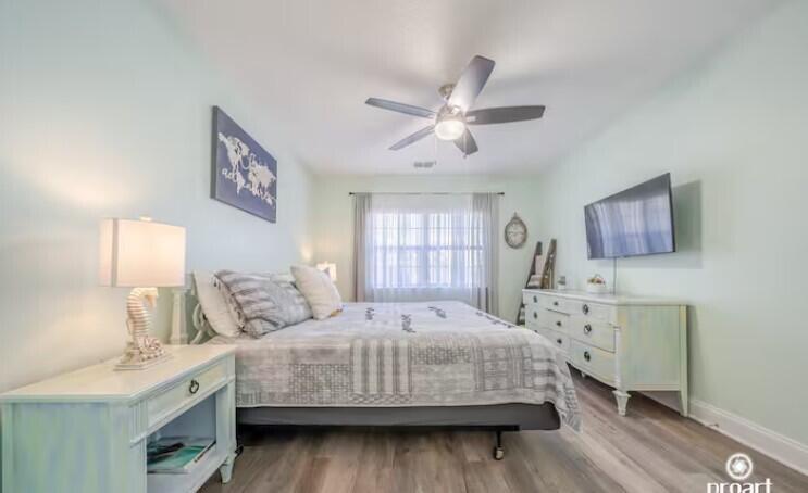 186 Durango Road Destin, FL 32541 - Photo 10 of 29 a bedroom with a bed wooden floor and window