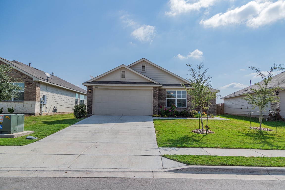 a front view of a house with a yard