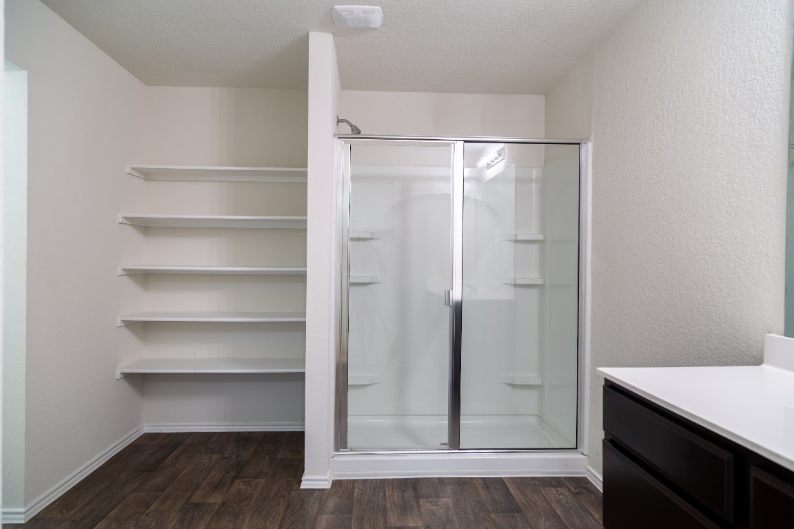 15225 Harkness Pass Austin, TX 78725 - Photo 11 of 23 a view of walk in closet with empty racks