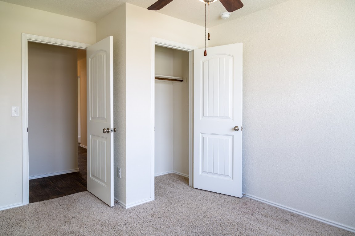 15225 Harkness Pass Austin, TX 78725 - Photo 14 of 23 a view of an empty room with a ceiling fan