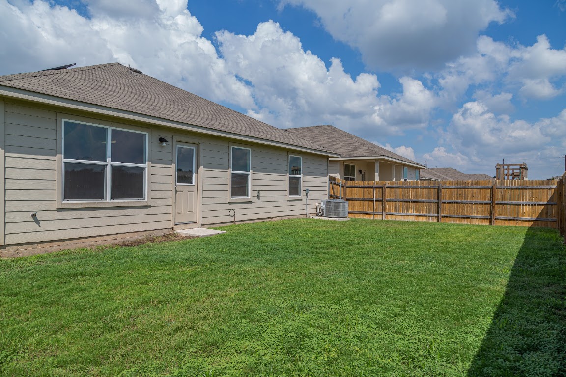 15225 Harkness Pass Austin, TX 78725 - Photo 20 of 23 a view of a backyard with plants and large tree