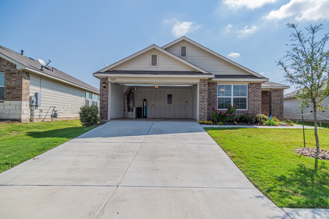 15225 Harkness Pass Austin, TX 78725 - Photo 23 of 23 a front view of a house with garden