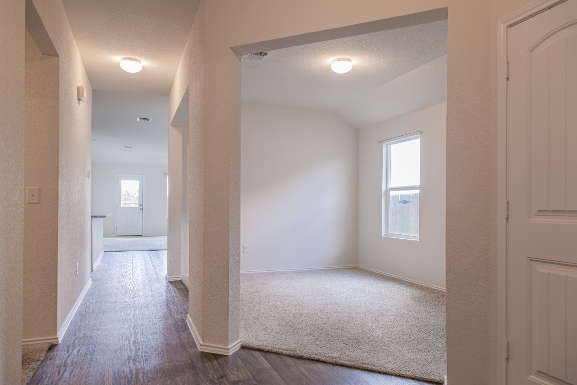 15225 Harkness Pass Austin, TX 78725 - Photo 3 of 23 a view of a hallway with wooden floor