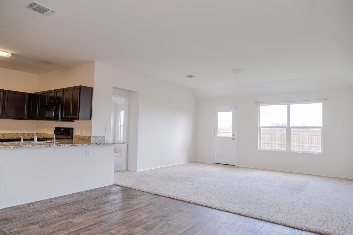 15225 Harkness Pass Austin, TX 78725 - Photo 4 of 23 a view of a kitchen with a sink cabinets and a window