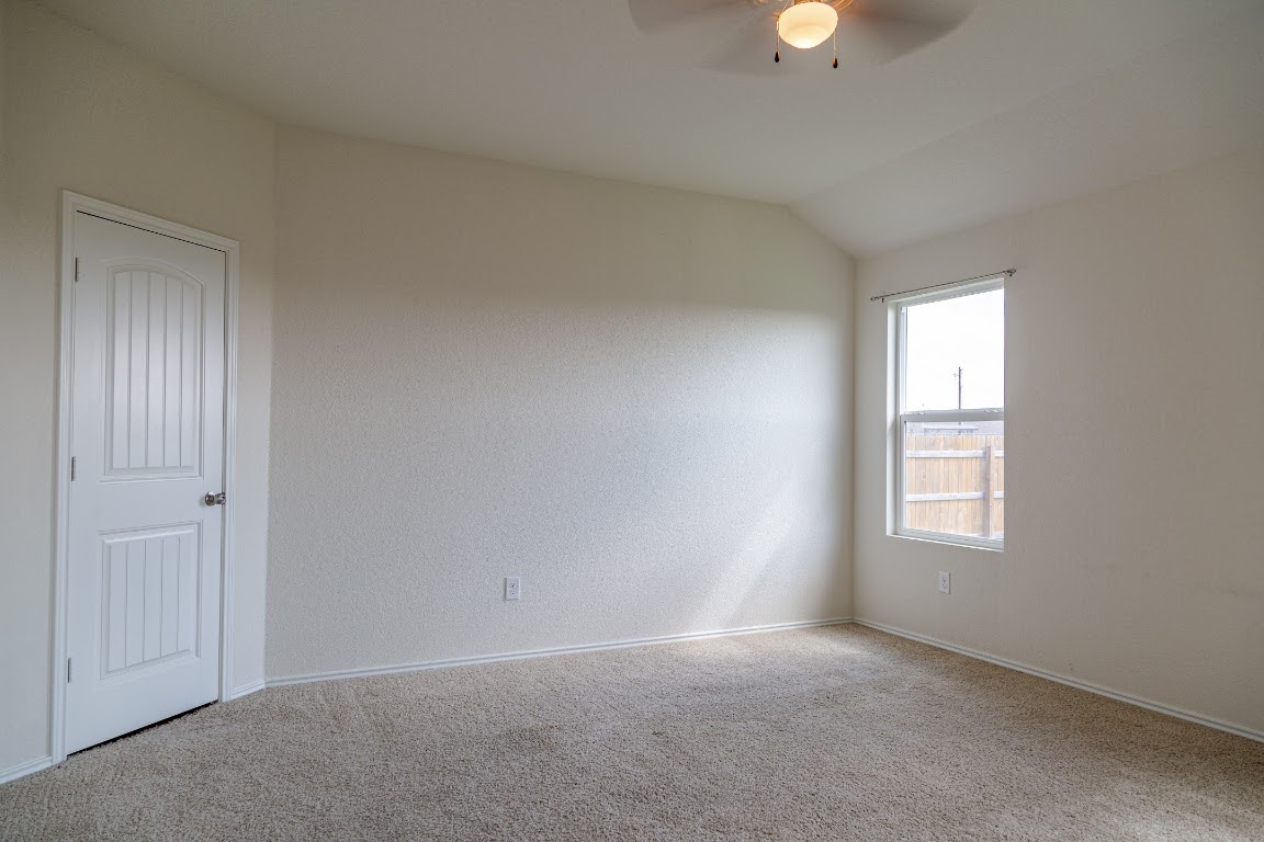 15225 Harkness Pass Austin, TX 78725 - Photo 9 of 23 an empty room with windows and closet