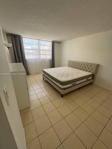 a room with pool table and window
