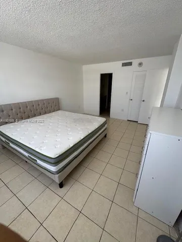 a spacious bathroom with a sink a large mirror and a shower
