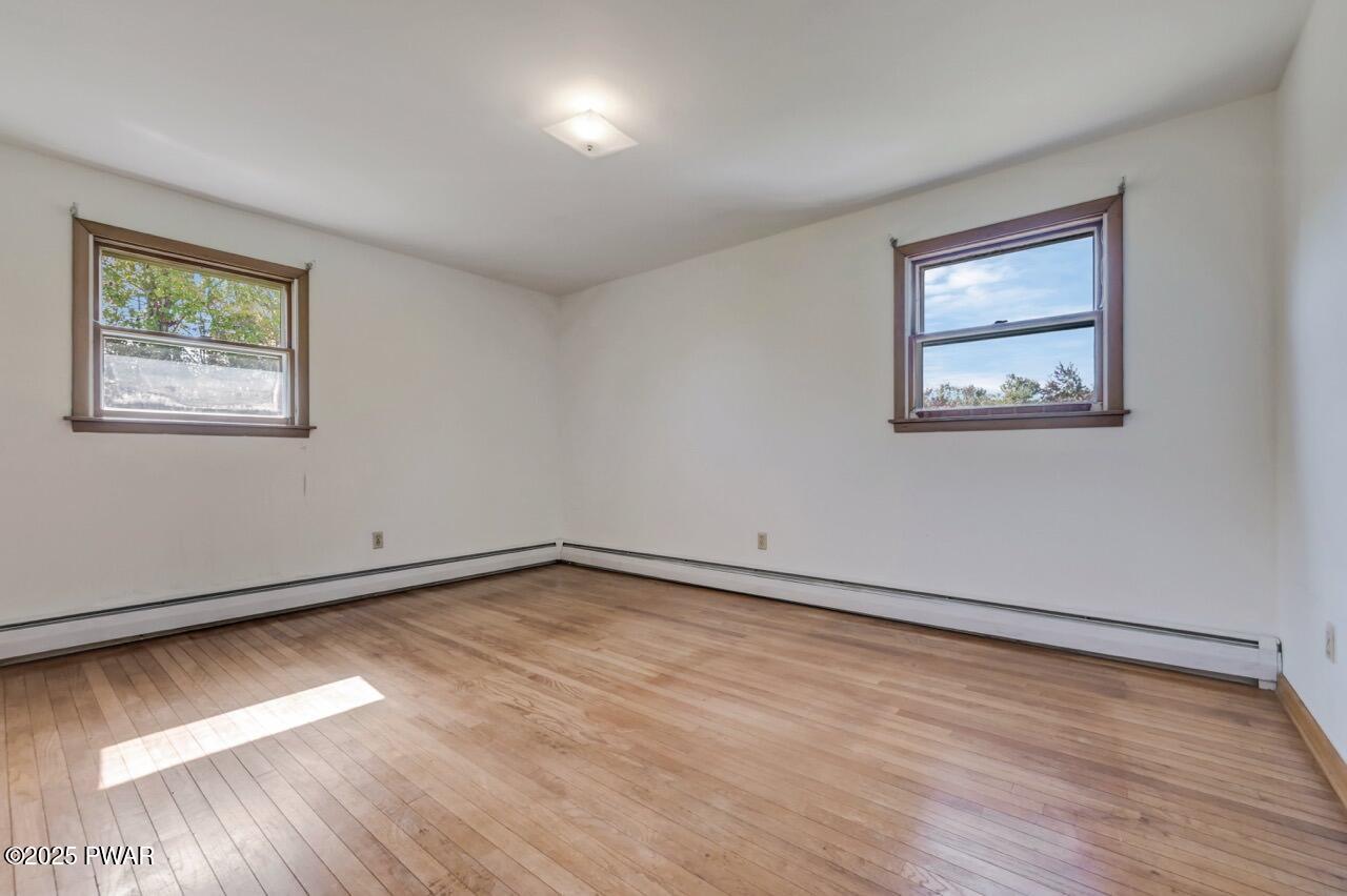 100 Spring Hill Road Moscow, PA 18444 - Photo 34 of 101 a view of an empty room with wooden floor and a window