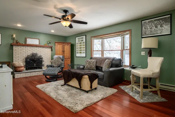a living room with furniture fireplace and window
