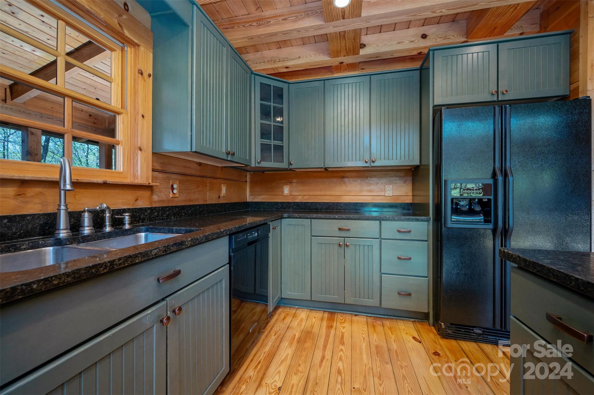 778 Pkwy N Road Mill Spring, NC 28756 - Photo 42 of 48 a kitchen with granite countertop wooden cabinets and a sink