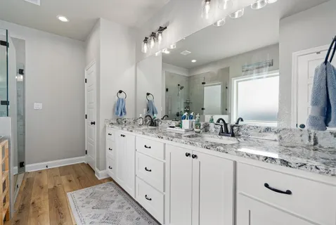 a bathroom with double sink and a mirror