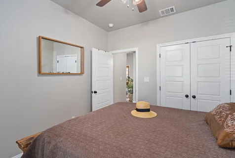 a bedroom with a bed and a painting on the wall