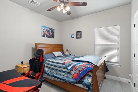 a bedroom with a bed and window