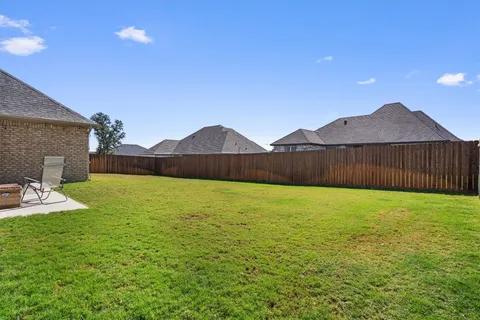 a view of an house with backyard and outdoor seating