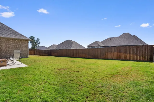 a view of an house with backyard and outdoor seating