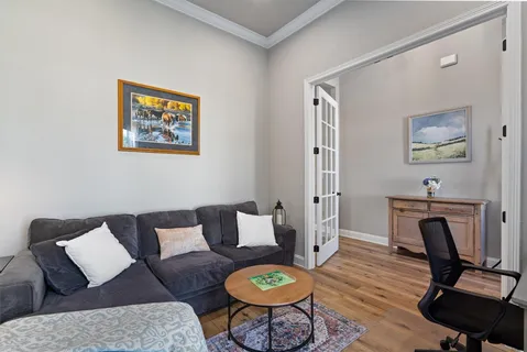 a living room with furniture a rug and a window
