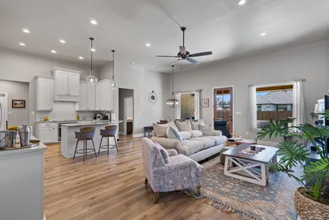 a living room with furniture and a wooden floor
