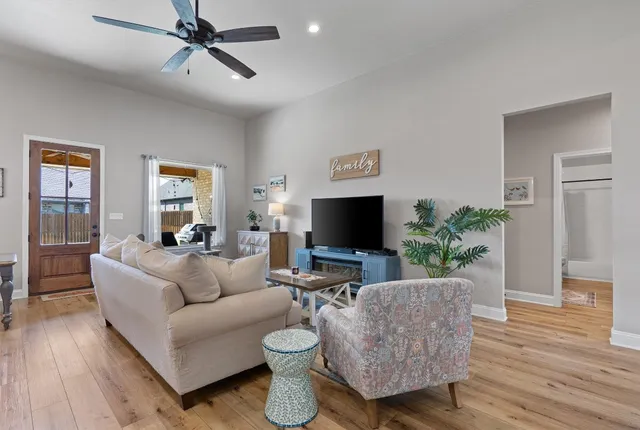 a living room with furniture and a flat screen tv