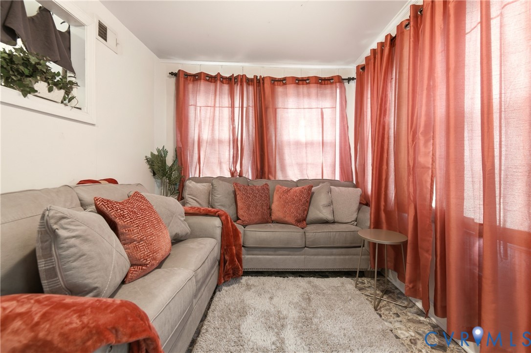 1311 Williamsburg Road Richmond, VA 23231 - Photo 23 of 38 Living area featuring multiple windows, white wall