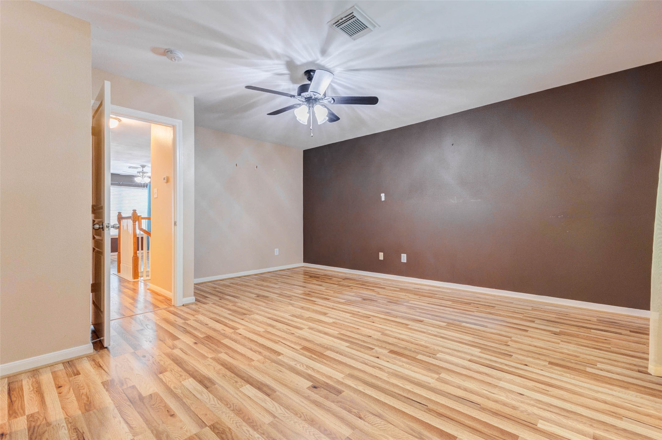 14522 Durham Chase Lane Houston, TX 77095 - Photo 26 of 40 an empty room with wooden floor chandelier fan and windows