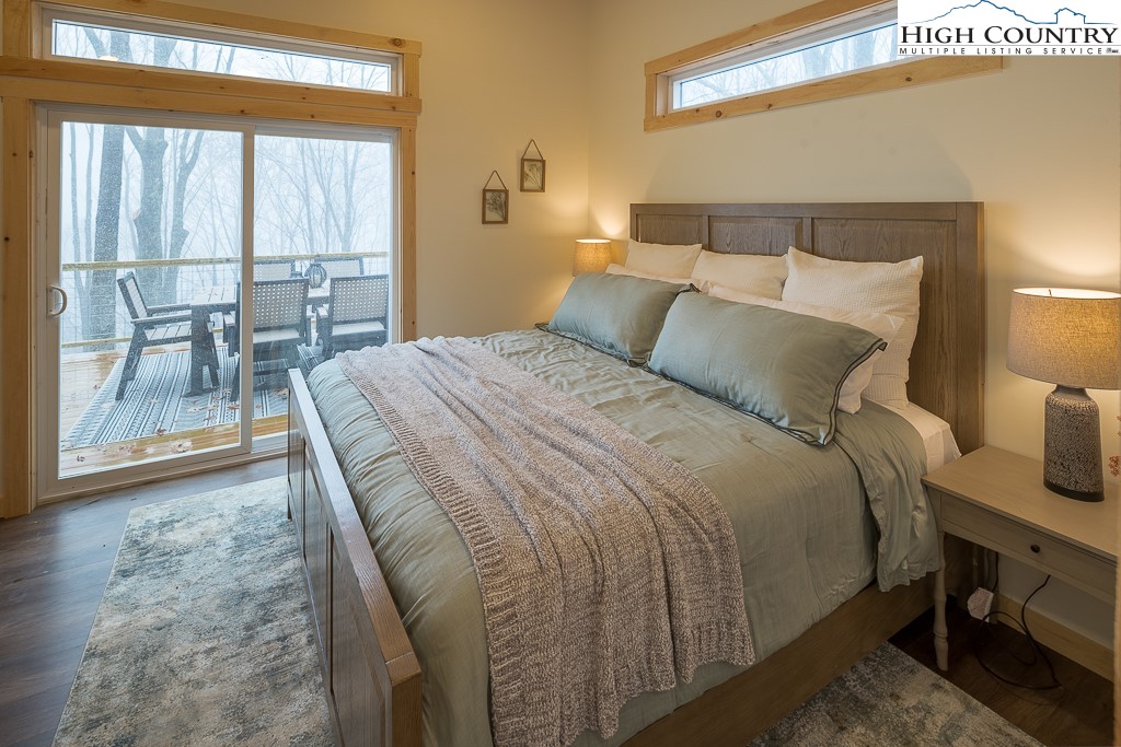 232 Wild Daisy Lane Beech Mountain, NC 28604 - Photo 19 of 49 a bed sitting in a bedroom next to a window