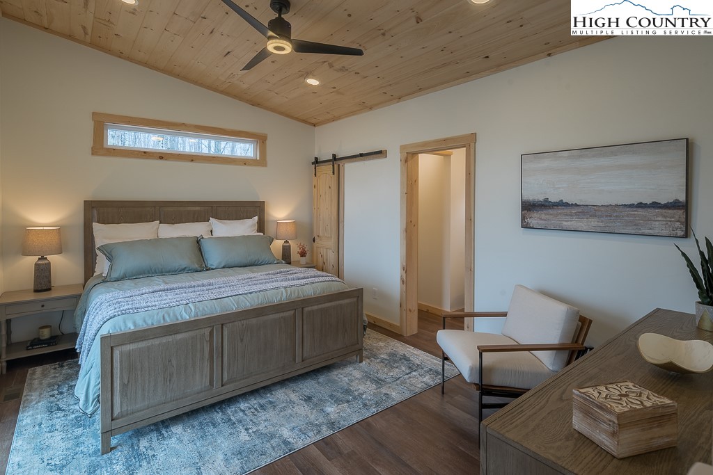 232 Wild Daisy Lane Beech Mountain, NC 28604 - Photo 20 of 49 a bedroom with a bed and furniture