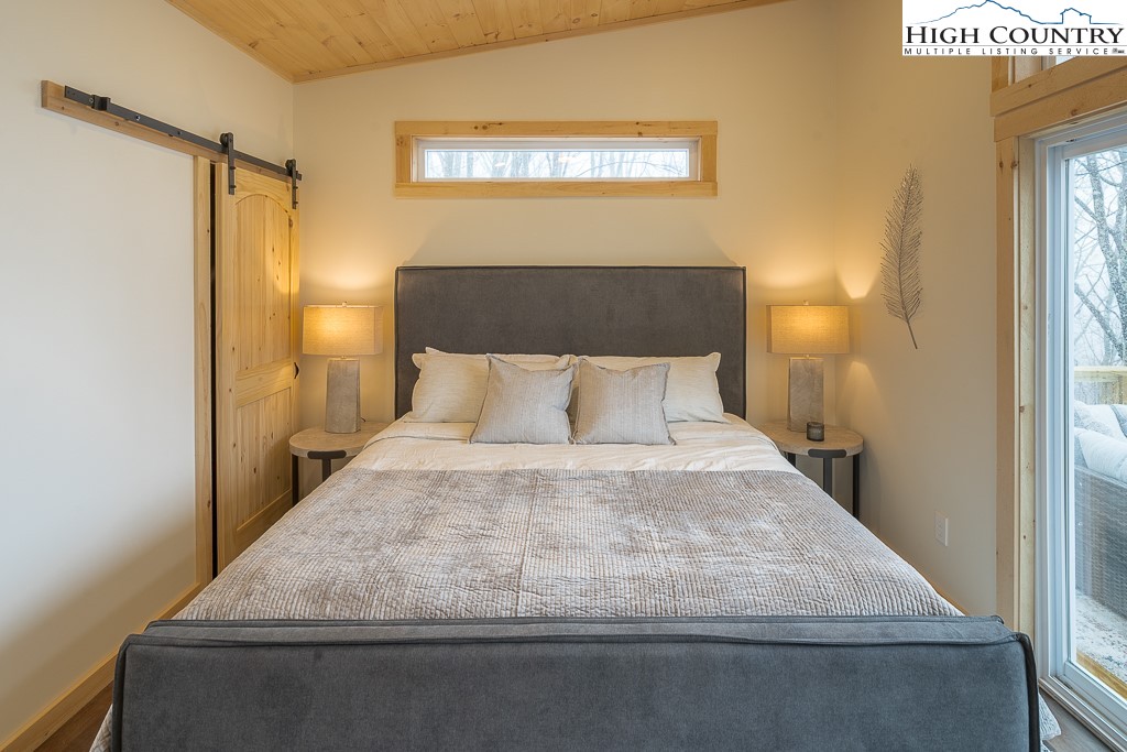 232 Wild Daisy Lane Beech Mountain, NC 28604 - Photo 27 of 49 a bedroom with a bed and window