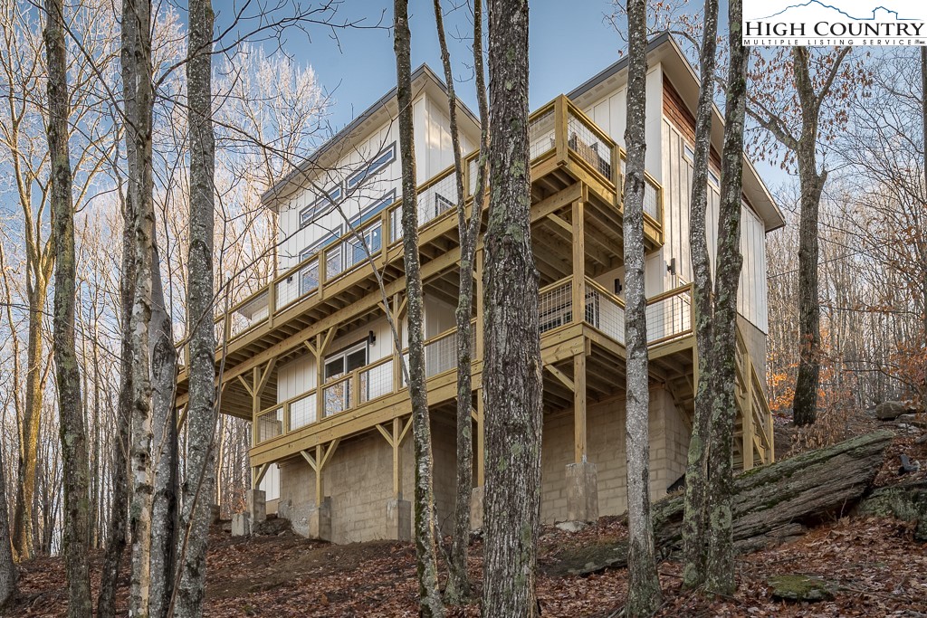 232 Wild Daisy Lane Beech Mountain, NC 28604 - Photo 3 of 49 a view of a building with a yard