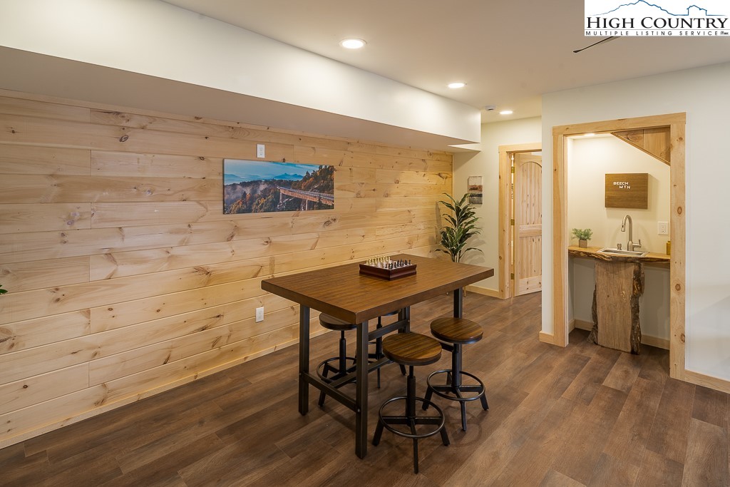 232 Wild Daisy Lane Beech Mountain, NC 28604 - Photo 35 of 49 a view of a dining room with furniture and wooden floor