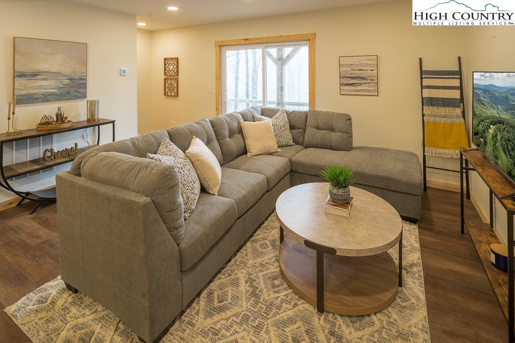 232 Wild Daisy Lane Beech Mountain, NC 28604 - Photo 36 of 49 a living room with furniture and a flat screen tv