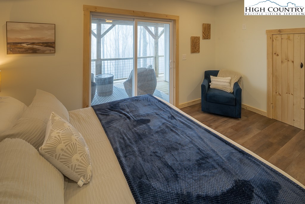 232 Wild Daisy Lane Beech Mountain, NC 28604 - Photo 38 of 49 a bedroom with a bed and wooden floor