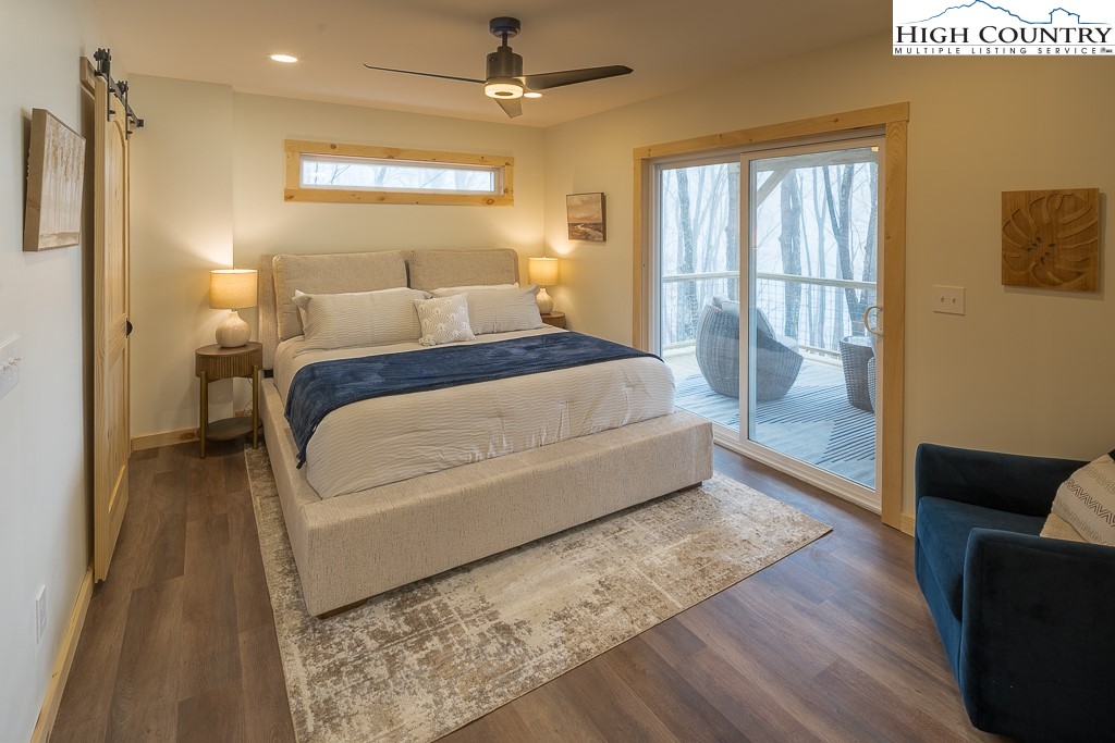 232 Wild Daisy Lane Beech Mountain, NC 28604 - Photo 39 of 49 a bedroom with a large bed and a couch