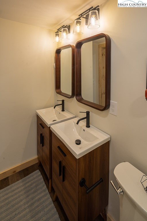 232 Wild Daisy Lane Beech Mountain, NC 28604 - Photo 40 of 49 a bathroom with a sink toilet and mirror
